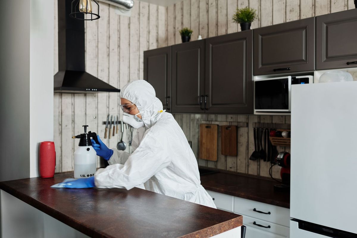 Cleaner preparing a bright vacation rental bedroom for incoming guests in Miami
